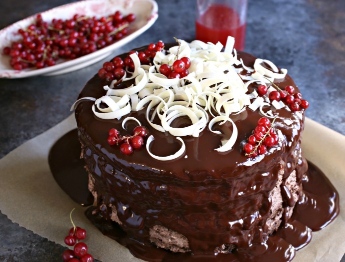 Recipe for a 4 layer chocolate cake with raspberry syrup, chocolate mousse filling and ganache topping.
