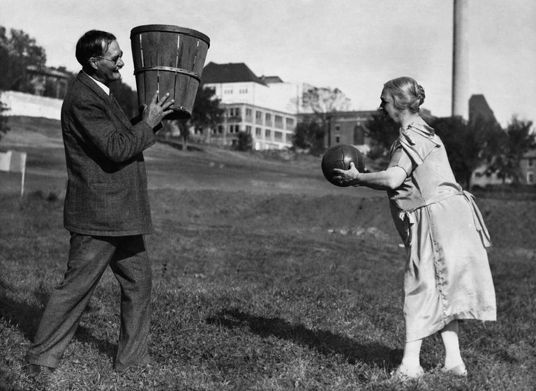 Inventor of Basketball, James Naismith, holding a fruit basket for his wife while she makes a basket. Baskets and Ladders. marchmatron.com Inventor of Basketball, James Naismith, holding a fruit basket for his wife while she makes a basket. Baskets and Ladders. marchmatron.com