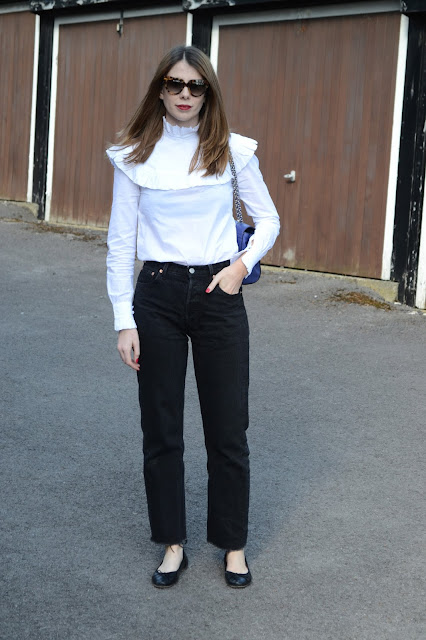 White frill shirt from Archive by Alexa Chung for Marks and Spencers, Black flat ballet pumps from Topshop, Black vintage Levis 501 Jeans, Blue Mulberry Lily bag.