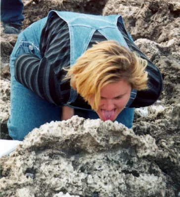 Geology student really getting down to earth by licking a block of salt on a desert playa.