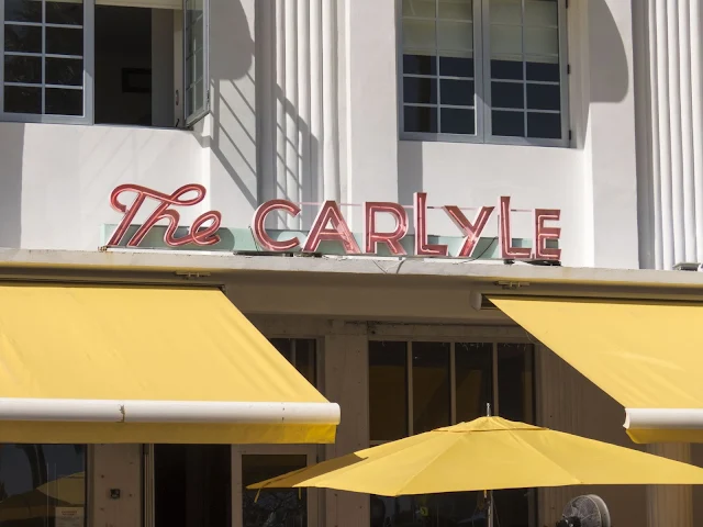 Neon sign and yellow umbrellas at the Carlyle in the Miami South Beach Art Deco Historic District