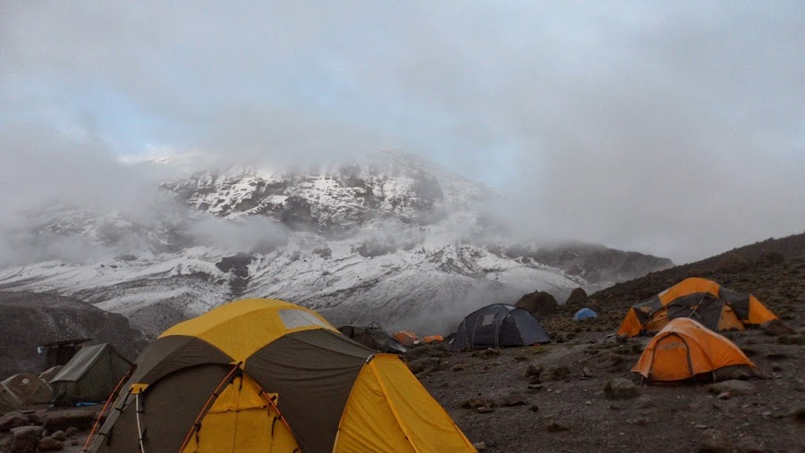 Tiendas-de-campaña-en-Karanga-Hut-bajo-la-niebla-con-la-cima-del-Kilimanjaro-de-fondo