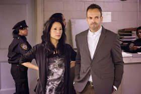 Jonny Lee Miller and Lucy Liu as Sherlock Holmes and Joan Watson in CBS Elementary Season 2 Episode 6 An Unnatural Arrangement