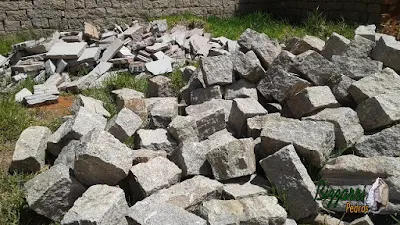 Pedra para parede de pedra tipo rachão de granito com corte manual na cor cinza escuro.