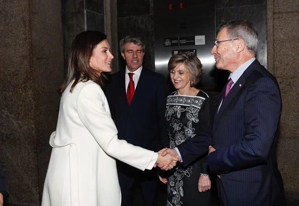 Queen Letizia wore a new printed skirt by Hugo Boss, and wore Carolina Herrera white cashmere coat, and Hugo Boss silk top