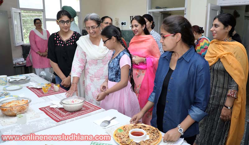 Guests looking at the dishes made by students during Summer Feast and Craft Expo at GNKCW