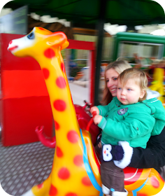 first time on merry go round, london zoo, one year old on merry go round