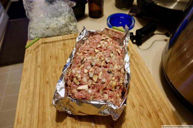 image of shaped bacon blue cheese mushroom meatloaf in foil boat