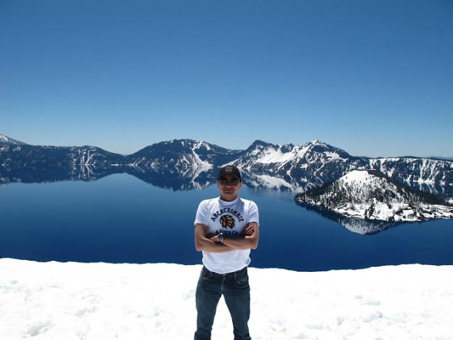 Crater Lake in Oregon, USA - A Wonderful PHOTO JOURNEY WITH Saurabh RathoreSaurabh visited Carter Lake few weeks back with his friends and they did camping around the lake. Let's have a PHOTO JOURNEY to Crater Lake with Saurabh...Crater Lake is a caldera lake located in the south-central region of the U.S. state of Oregon. It is the main feature of Crater Lake National Park and famous for its deep blue color and water clarity. The lake partly fills a nearly 2,148-foot (655 m) deep caldera that was formed around 7,700 (± 150) years ago by the collapse of the volcano Mount Mazama. There are no rivers flowing into or out of the lake; the evaporation is compensated for by rain and snowfall at a rate such that the total amount of water is replaced every 250 years. [Source: Wikipedia]Conquering the lake. The mountains look almost blue and the entire scenery has only two colours: Various shades of blue and white.Getting ready to camp in the wilderness. There's no feeling more liberating. Despite the snow, there was no need to cover oneself under layers of clothes.Camps all ready. T-shirts amongst the snow. Sounds like a bollywood concept. I think this is the Wizard island. It puts its head out through the waters. The color of the vegetation is darker. The site is considered sacred by the klamath tribe of Native Americans. Their ancestors are supposed to have witnessed the collapse of the maountain. The trek seems easy in pictures but wasn't without its own difficulties.Pine trees jutting out of the untouched blanket of snow. A sight very common in these surroundings. This looks like the original surface of Mount Mazama whose collapse had formed the crater. I can't be sure though. Look at the layers of snow behind. It seems that the snow in these parts of the world hasn't melted in centuries.The road appears more snake like in this area than any other because it's blackness is emphasized by the white surroundings.The round shape of the crater is very clear here. It is amazing how nature seems to favour round and spherical things. Our vehicle - comfortable and elegant - perfect for such terrain.This looks like fresh snow. I still  cannot understand the comparatively warm temperatures.The rocky terrain is mostly hidden under the thick layers of snow. The terrain can be trecherous so caution is advised.Here begins our time as explorers.