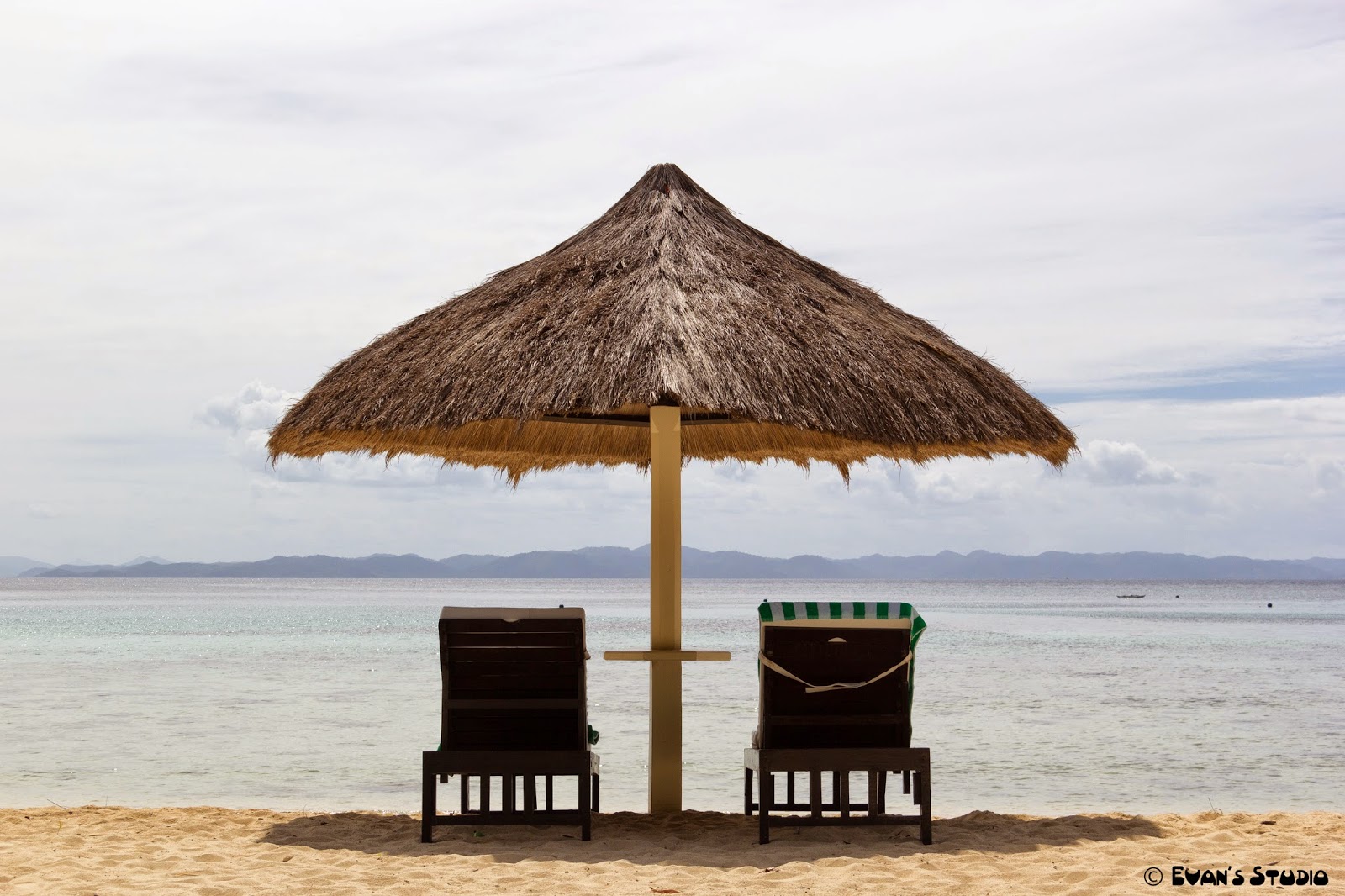 Seats for two on the beach at Apulit Island Resort, in the Philippines.