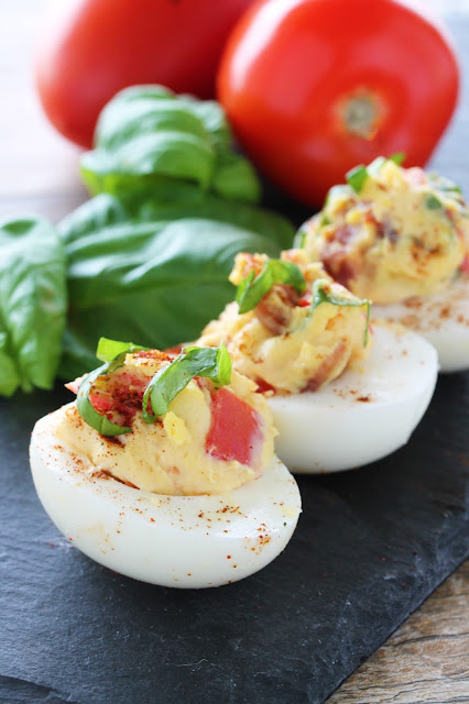Bacon, Basil (in place of lettuce), and Tomato form this BLT Deviled Egg. This appetizer may be simple, but it packs a punch. The secret is the candied bacon.