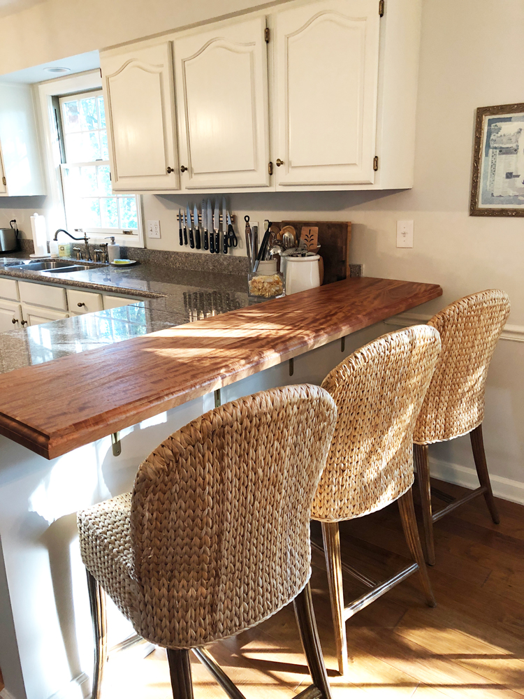 kitchen with wood peninsula and wicker bar stools