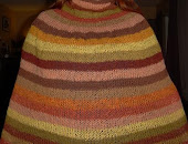 Knitted poncho out of mushroom and plant dyed woolyarn