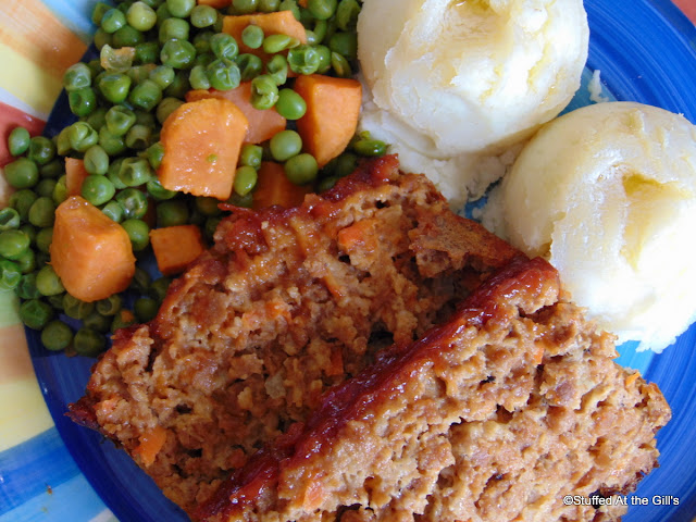 Vegetarian Meatloaf on plate with mashed potatoes and peas and carrots.