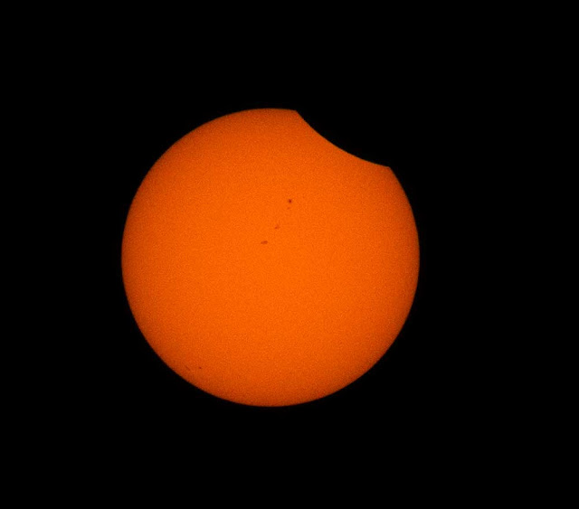 Sunspots visible as the eclipse begins.  2x magnification, 300mm, 1/4000 sec, f11 (Source: Palmia Observatory)