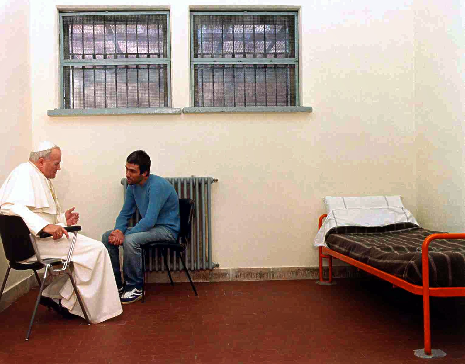 A photo of Pope John Paul II in a cell with his assassin, Mehmet Ali Agca