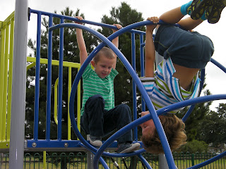 kid upside down on climbing frame