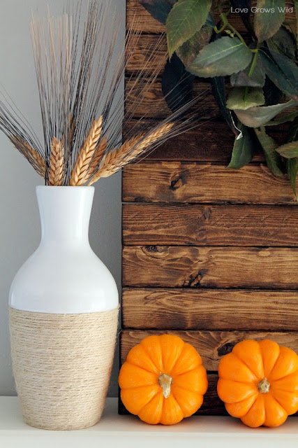 A kitchen beautifully decorated for Fall with sheet music garlands, mini pallet art, and more!