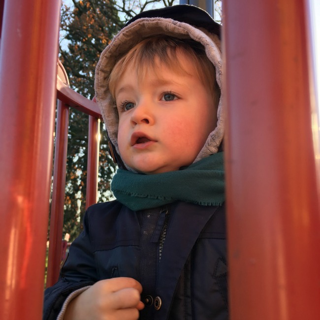 Sun-and-ice-toddler-at-top-of-slide
