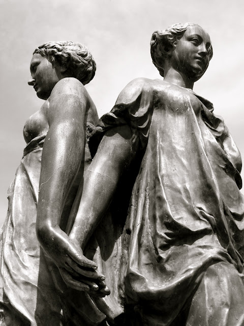 3 women holding hands statue photograph
