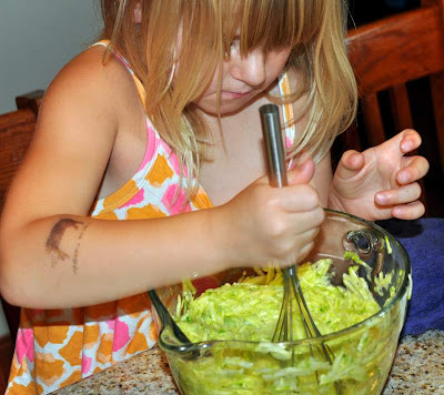 Crispy zucchini fritters being stirred