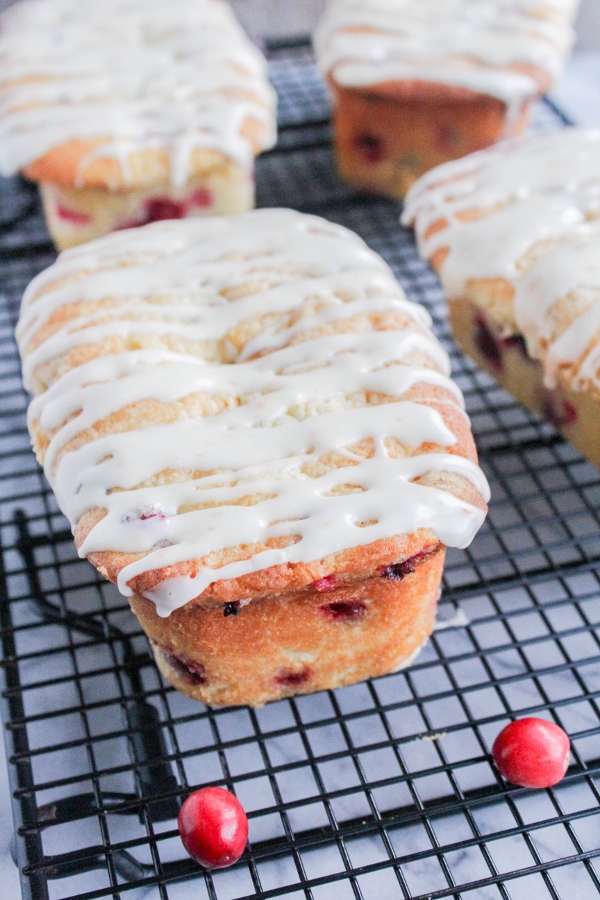 These Mini Orange Glazed Cranberry Loaves are tender and moist and bursting with flavor. It's the perfect recipe to share with friends and family this holiday season!