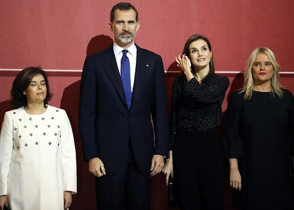 Queen Letizia wore Uterque Blouse, carried Nina Ricci Arc Clutch, Magrit Shoes, Tous Jewelry Earrings, wore Boss Trousers