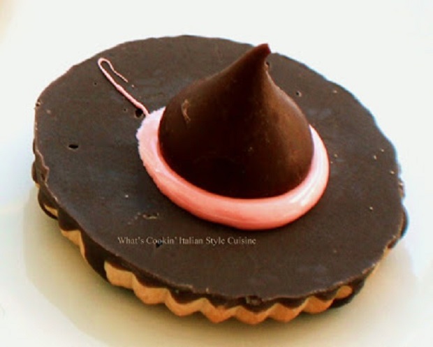 These are homemade cookies with a hershey kiss in the middle and frosting to glue it on to make a witch hat at Halloween