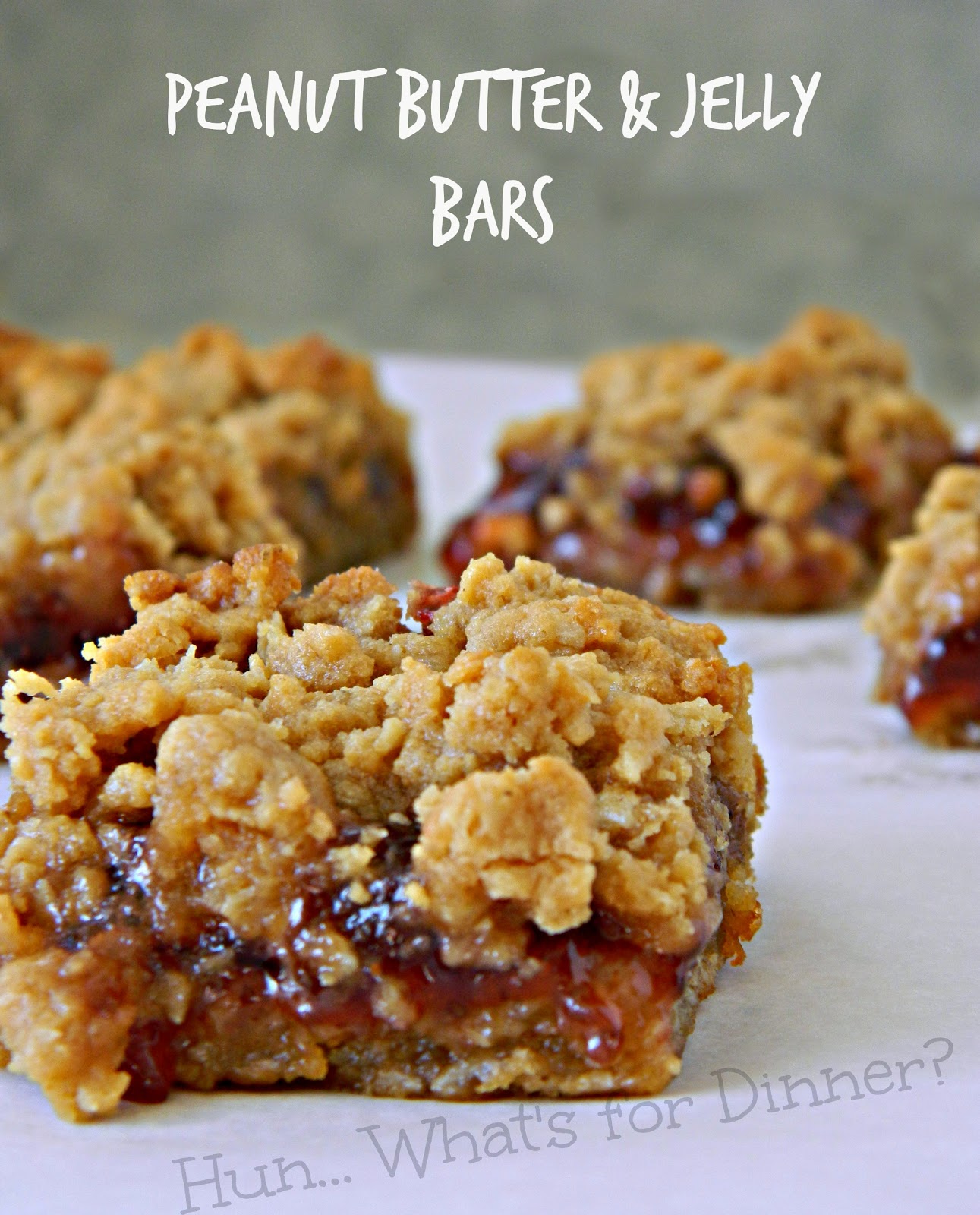 Hun... What's for Dinner? | Peanut Butter & Jelly Bars- These soft and chewy oatmeal peanut butter bars, have a gooey sweet layer of strawberry jam in the centre.