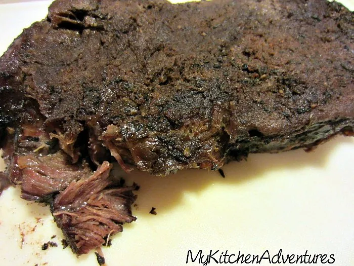 Slow Cooker BBQ Beef roast ready for shredding on the cutting board