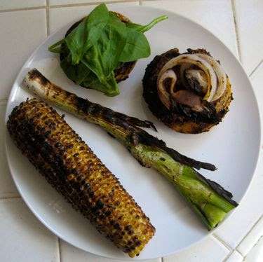 grilled corn, scallion, red onion, lamb burger, and spinach on sourdough bun with lemon-cayenne butter