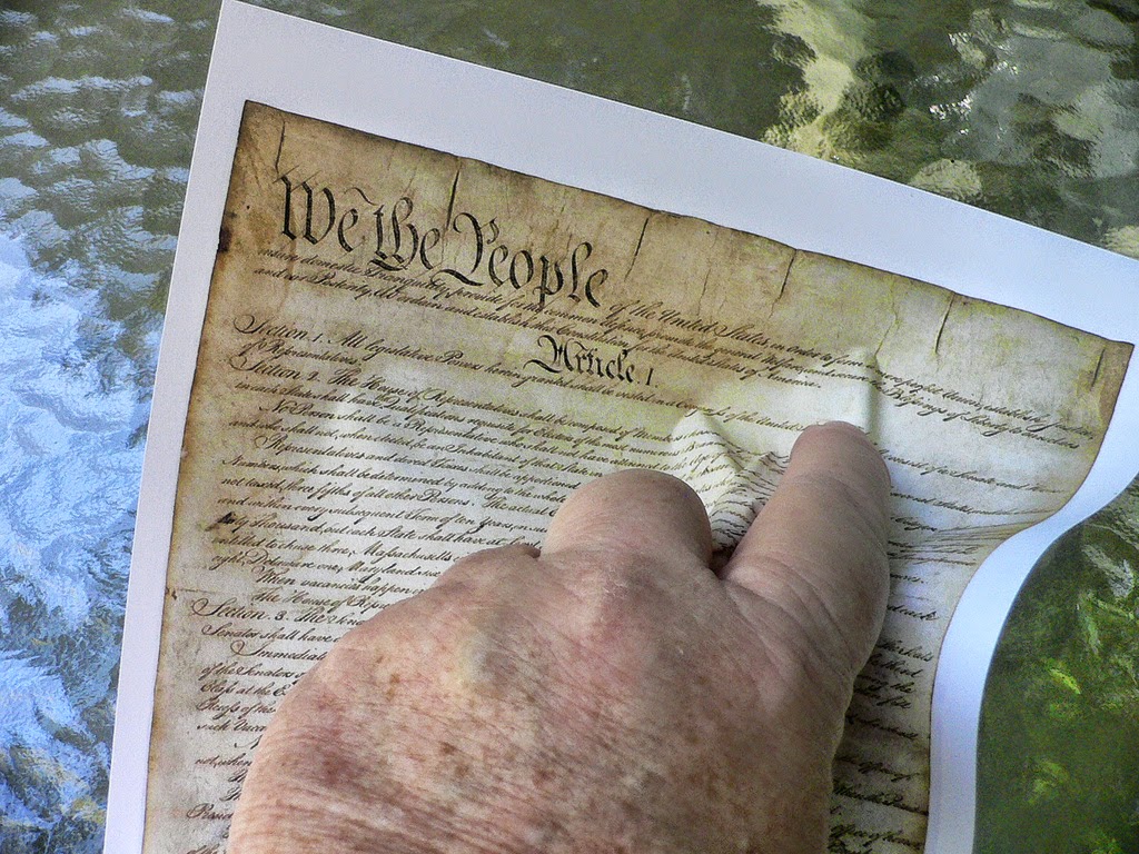 Hand crunching the declaration of independence, Independence Day (C) By Bev Sykes