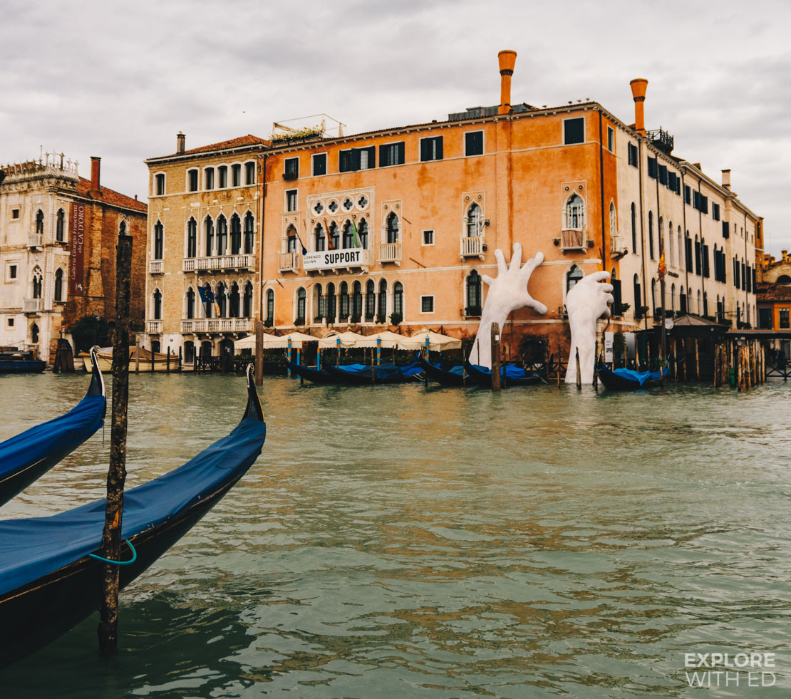 Hand sculpture in Venice highlighting the fragility of the city against the sea