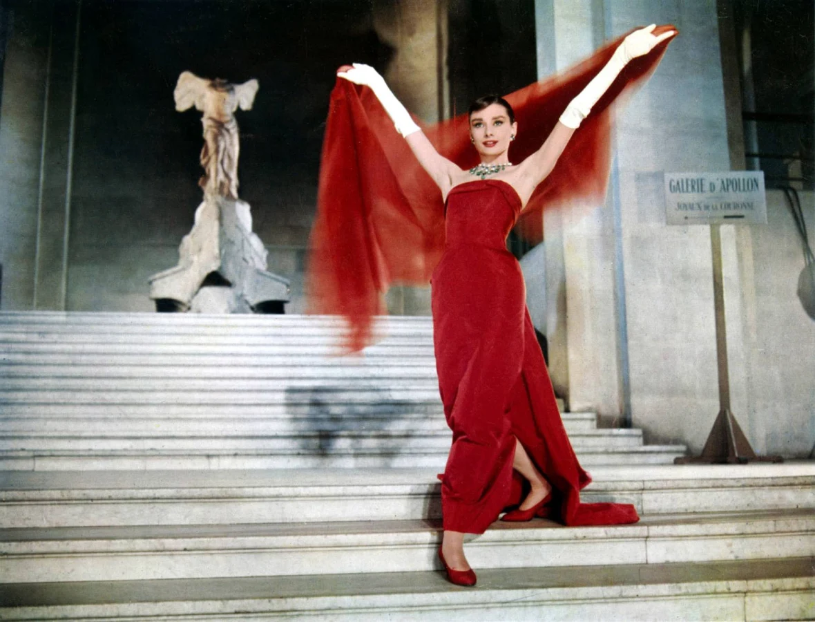 Audrey Hepburn posing in front of “Winged Victory at Samothrace” in the Louvre, Still from Funny Face, 1957