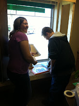4-H Members Installing a Window Display at the Library.
