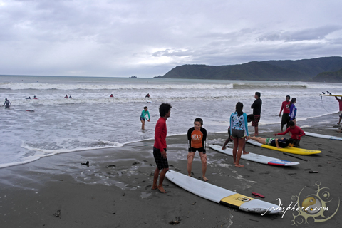 Visitors getting one on one surfing lessons before hitting the waves.