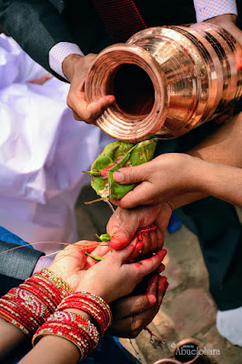 Recipientes dorados con agua cristalina sobre las manos de los novios. Una boda según el ritual hindú. 21 días en Nepal - "La BODA"