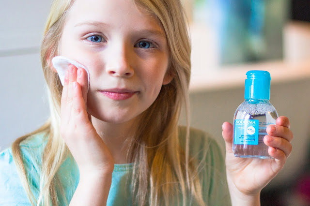 A child applying ABCDerm micellar water with cotton wool