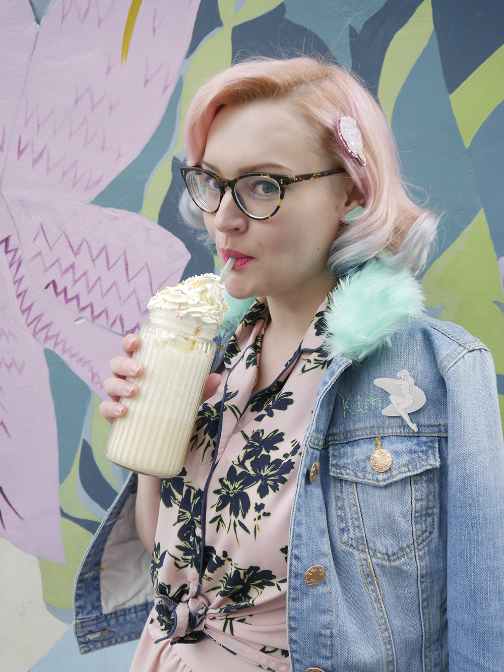 Pastel pink haired girl with 50s retro diner style drinking a milkshake