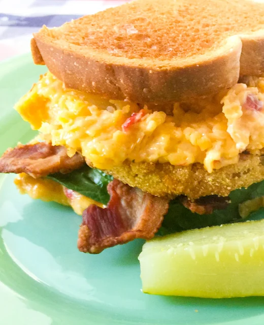 Fried Green Tomato, Bacon and Pimento Sandwich, homemade pimento cheese, crispy bacon, glorious fried green tomatoes sandwiched between two slices of golden toasted bread.  The ultimate summertime sandwich that sings the taste of the South.