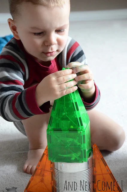 Toddler building a magnetic tiles rocket using Magna-Tiles and a tin can