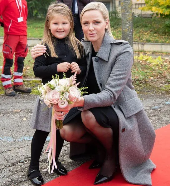 Princess Charlene wore Louis Vuitton wool cashmere grey coat with black Jimmy Choo pumps. Italian and Monegasque Red Cross