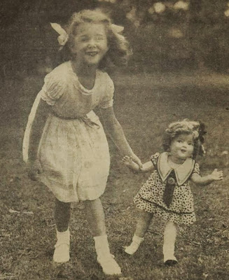 A little girl with copy-cat hair and a Shirley Temple doll, 1936