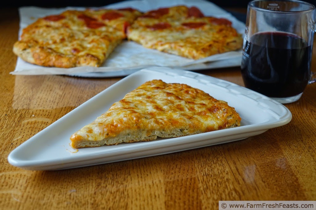 a slice of cheese pizza made with roasted garlic and pesto pizza dough