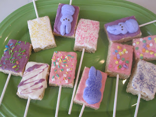 Easter Rice Krispie Pops are rice Krispie treats dipped in candy coating and covered in sprinkles and peeps. Life-in-the-Lofthouse.com