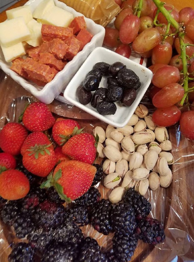 This is a cheese, wine, fruit, olives and board built with all kinds of appetizers to include