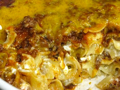A close up photo of sour cream noodle back with melted cheese and meat