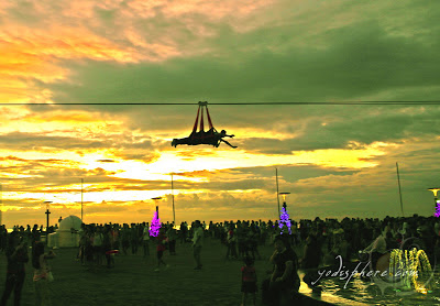 Two riders riding the zipline against the sunset at SM Mall of Asia