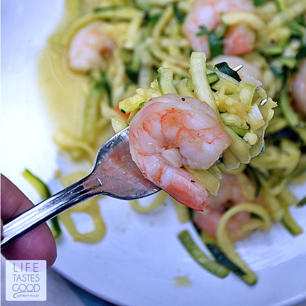 Shrimp Scampi Zoodles | by Life Tastes Good is a lower carb version of a traditional Shrimp Scampi recipe typically served over pasta. This recipe still has all the fresh tasting garlic and buttery goodness of the traditional recipe, but is served over zucchini noodles, or the more fun way of saying it 'zoodles', to get rid of all those carbs from the pasta. Just for the record... I didn't miss the pasta at all!