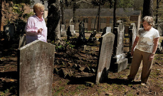 Two people taking in a graveyard